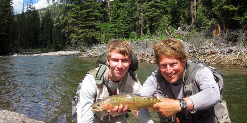 Angler and large rainbow-cutthroat hybrid in July