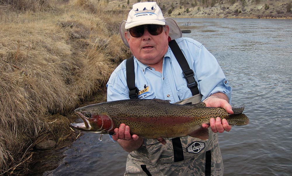 angler and large rainbow trout caught wade-fishing on a montana jet boat fishing trip