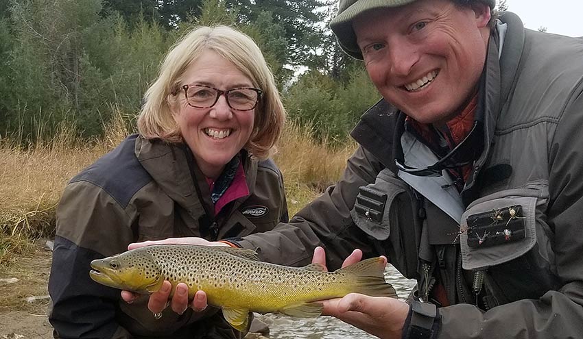 Angler, yellowstone fishing guide, and fall-run brown trout