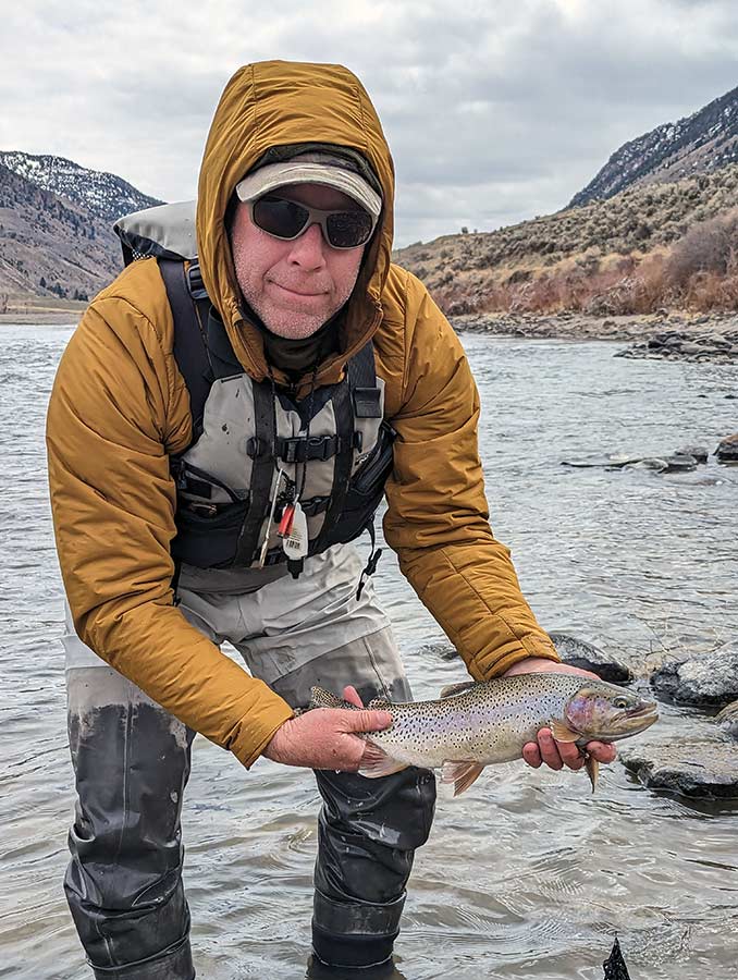 angler with cutt-bow trout