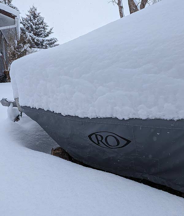 RO drift boat covered by snow in mid-April