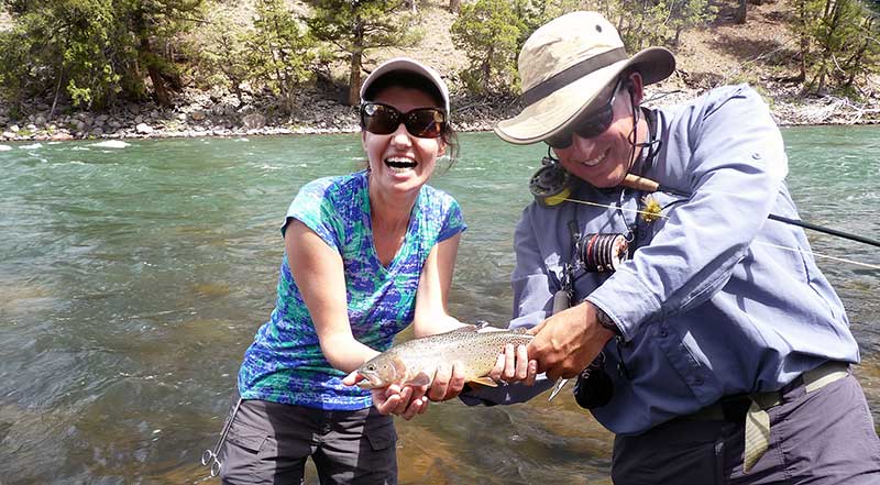 Happy angler with cutthroat trout