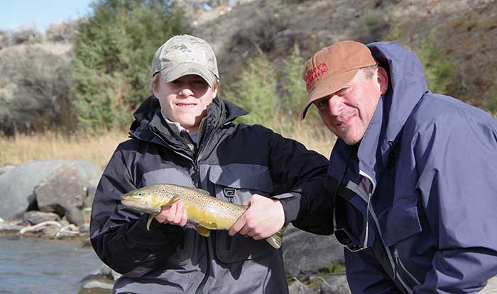 anglers with a fall brown trout