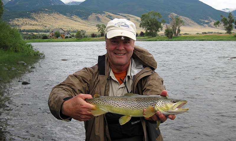 angler with brown trout