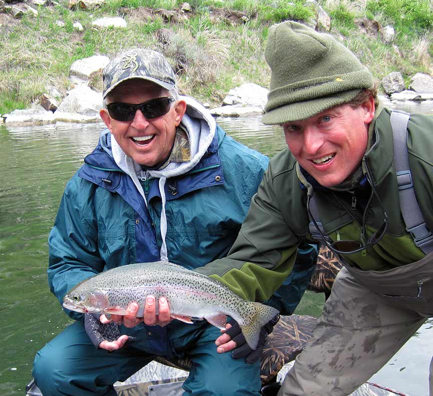 Smiling angler and Livingston Montana fly fishing guides with rainbow trout