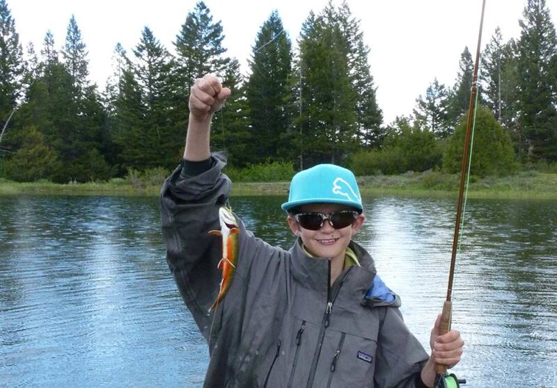 young angler with brook trout