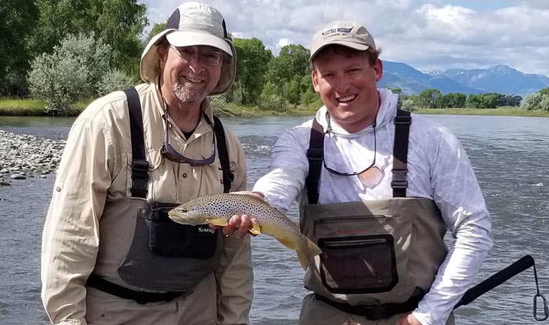 angler and guide with yellowstone river brown trout