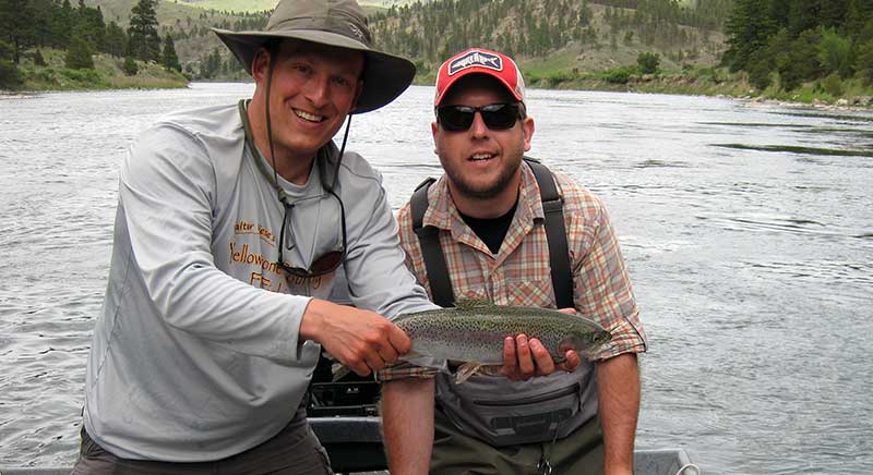 angler and guide with power boat rainbow trout