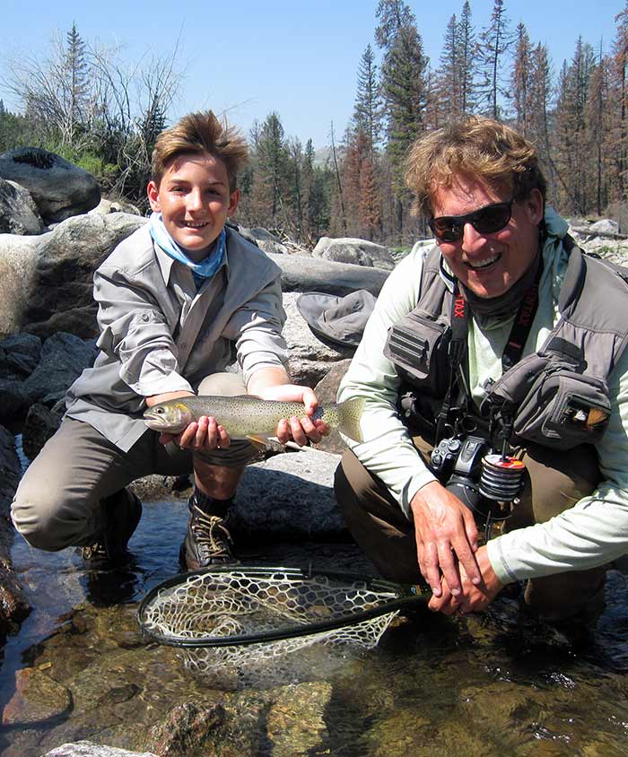 young angler and guide with cutthroat trout in Yellowstone Park
