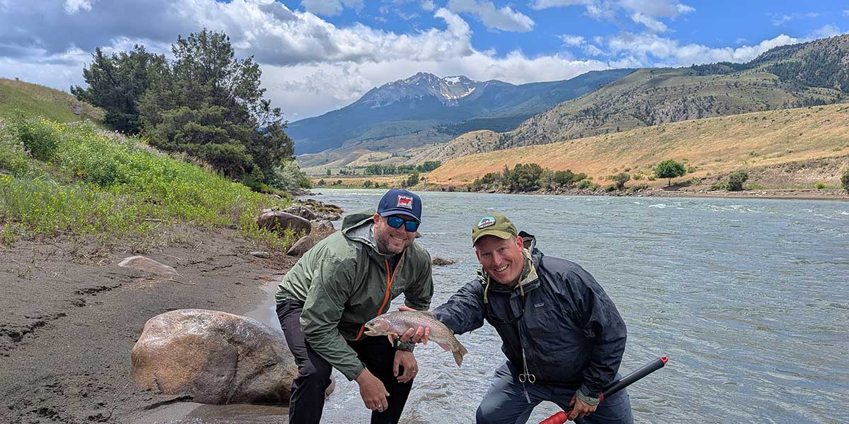 decorative image showing a fly fishing scene. may include happy angler, trout, scenery, etc