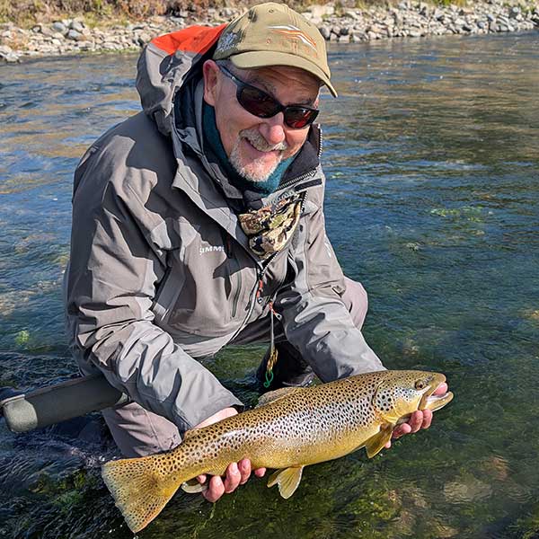 angler with large brown trout