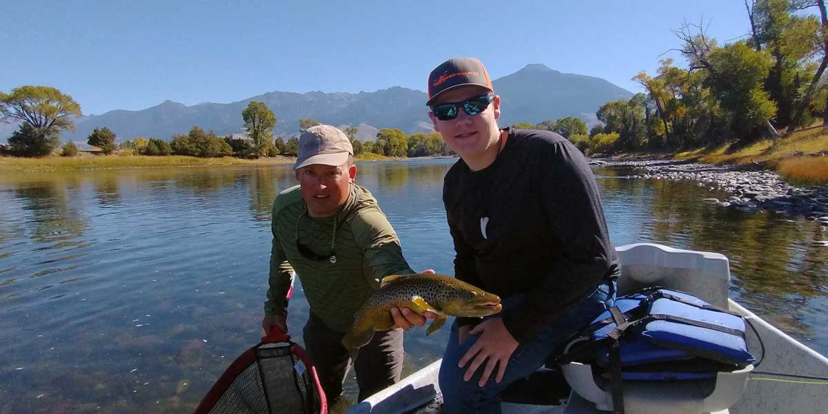 decorative image showing a fly fishing scene. may include happy angler, trout, scenery, etc